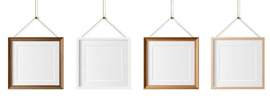 Set of blank picture frames hanging on white background