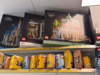 Fototapeta premium Shelves filled with lego building set boxes in a toy store aisle