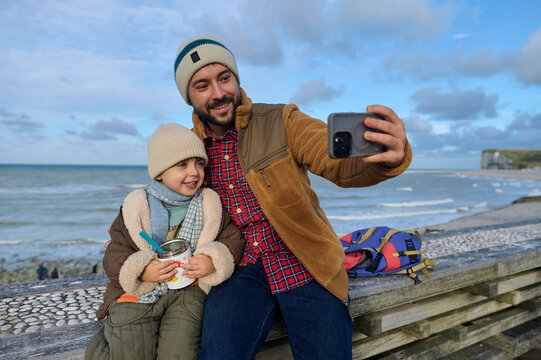 Dad and son have a fun on the beach