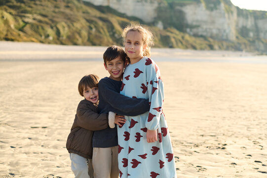 portrait of three children on a sunny beach