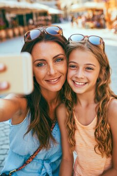 Mother and daughter smiling taking a selfie travel, vertical