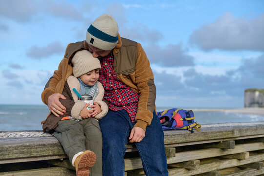 Dad and son have a fun on the beach