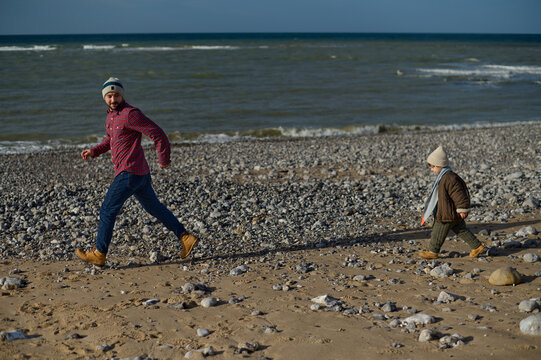 Dad and son playing on the beach