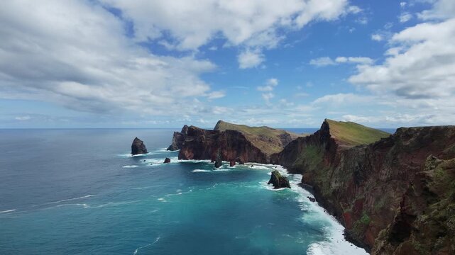 Drone aerial view of dramatic cliffs and sea stacks at Ponta de S&atilde;o Louren&ccedil;o, Madeira, with turquoise ocean and green vegetation.