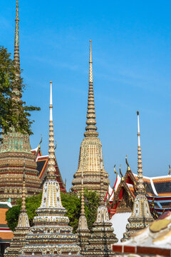 Buddhist Temples With Tall Spires Under a Clear Blue Sky