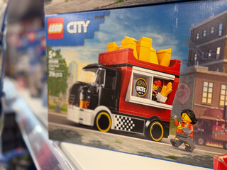 Obraz premium Lego city toy box showing a fries food truck and minifigure on a store shelf