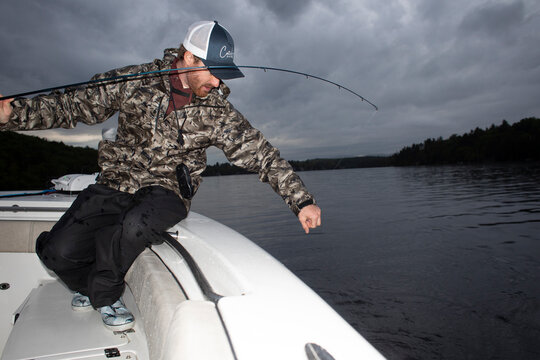 Fishing guide reel in fish Lake New Hampshire 