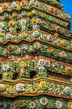 Bright Tiles and Flowers Decorate a Temple Structure in Bangkok