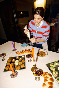 Chef adding final touches to appetizers for home dinner party