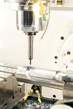 Close-Up of a CNC Milling Machine Cutting a Polished Metal Cylinder