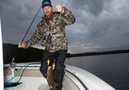 Fishing guide reel in fish Lake New Hampshire 
