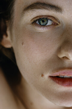 Woman's Close up Portrait with green eyes with heterochromia