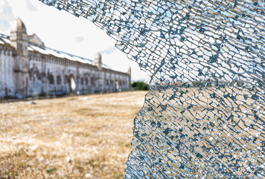 Detailed image of a broken and cracked tempered glass window.