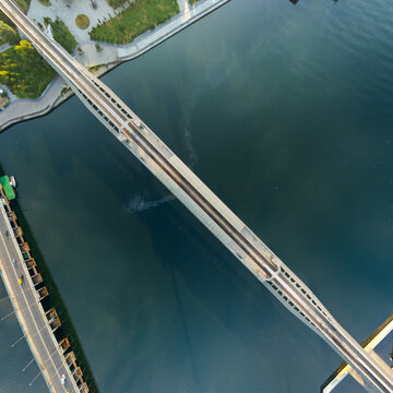 Istanbul, Turkey. Top-down aerial view of Halic Metro Bridge station over Golden Horn, railway tracks, platforms and modern architecture. Aerial view