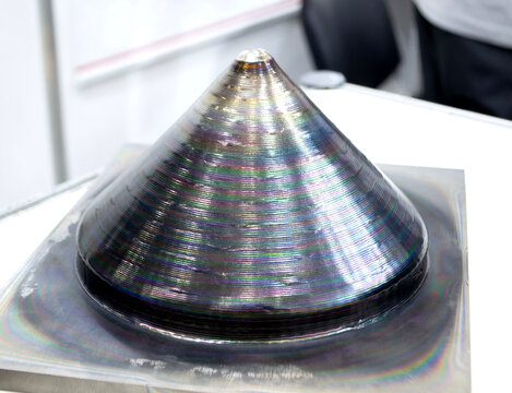 Model conical shape manufactured industrial 3D metal printing. Additive manufacturing. Metal alloy. Object printed on 3D printer from metal. Layer-by-layer deposition of metal thread. 3D printing