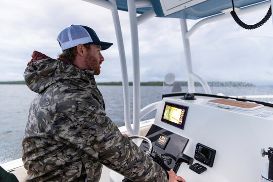 Confident Boat Fisherman Portrait smile at helm Fish finder