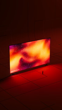 A man stands in front of a large digital screen