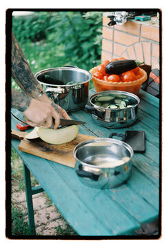 Summer cooking spread across a weathered teal garden table