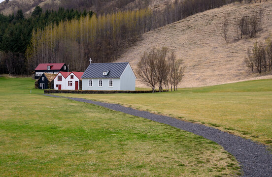 Historic Skogar Church and traditional grass-roof turf houses at the Skogar Museum in South Iceland.
