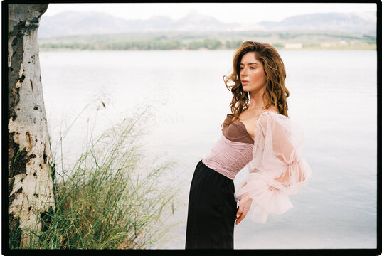 Woman posing lakeside 