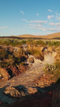 vertical Scenic Epupa Falls flowing on the Kunene River in Namibia