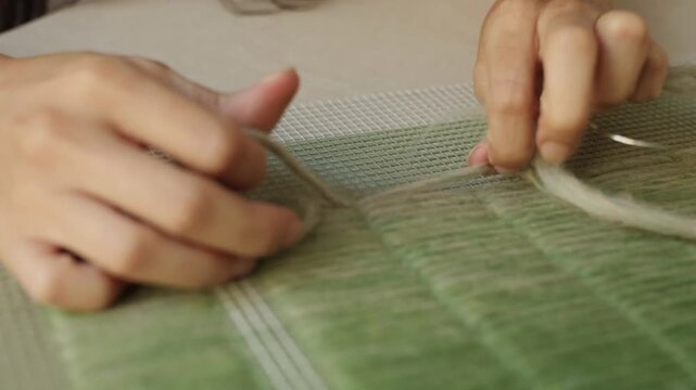 Artisan shaping natural wool fibers by hand during textile creation