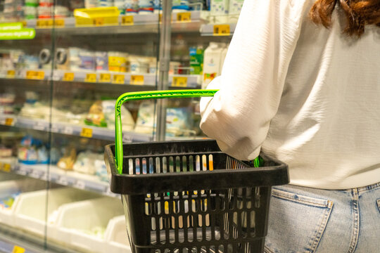 Exploring the Aisles of a Grocery Store with a Shopping Basket Filled with Everyday Essentials and Fresh Products for Healthy Living Choices