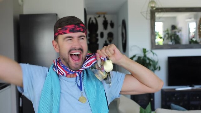 Sporty man showing many medals