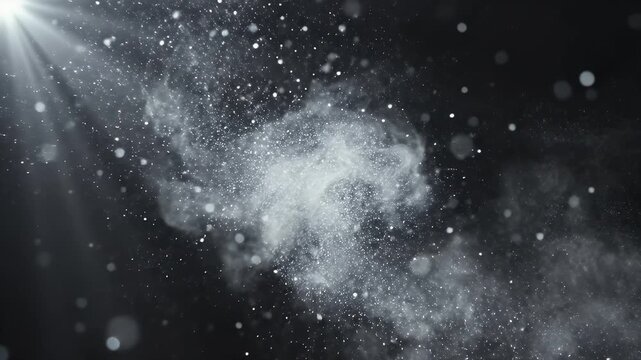 A gentle beam of light illuminates floating particles against a dark background.