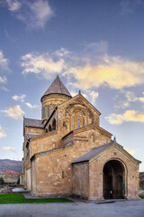Obraz premium Ancient Svetitskhoveli Cathedral stands in historic Mtskheta, Georgia. Front facade view in warm evening sunset light