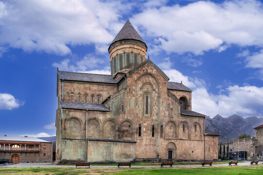 Historic Svetitskhoveli Cathedral rises inside the monastery courtyard in Mtskheta, Georgia. Side view in sunny daylight