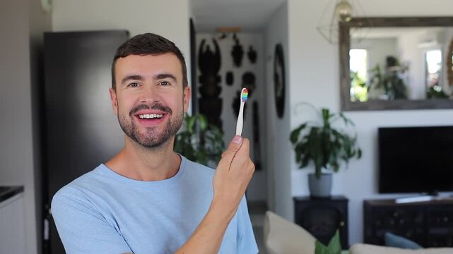 Handsome man brushing his teeth