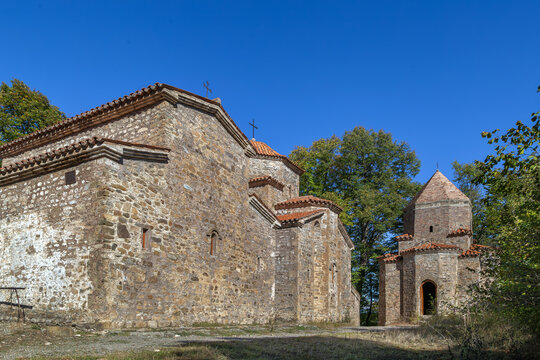 Ancient Dzveli Shuamta churches stand inside the stone monastery courtyard, Georgia. Side view in bright daylight