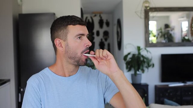 Handsome man brushing his teeth