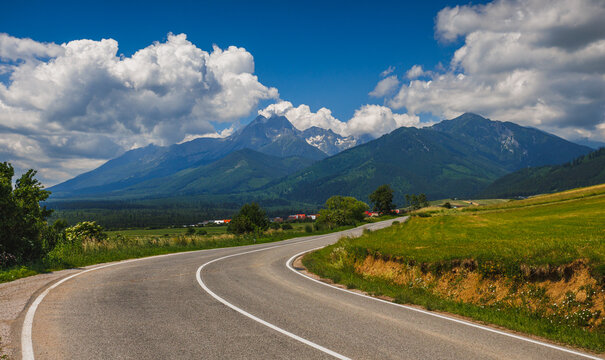 Sunlit green mountain valley with meadow, forested slopes in Zakopane Tatras mountains
