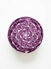 Fototapeta premium Purple cabbage cross-section showing a spiral pattern on a white background