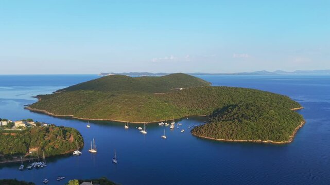 Aerial view of Yachts anchored at Saint Nicholas Island in Syvota scenic islet off the coast of mainland Greece
