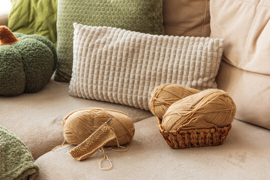 Knitting project with yarn and needles on couch