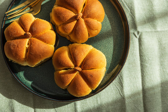 Pumpkin shaped bread rolls on a plate for autumn