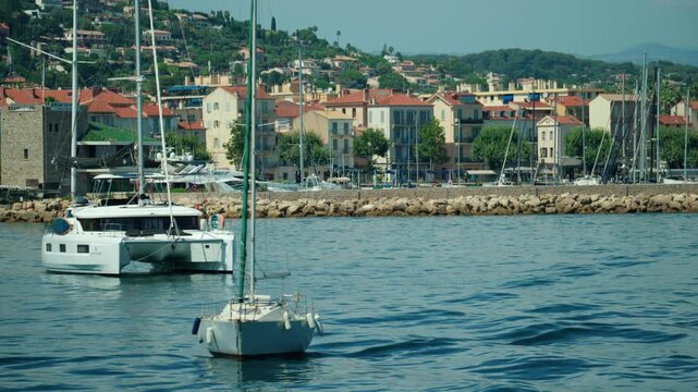 French riviera town of saint-Raphael with boats in the coastal harbor, representing vacation and tourism, Golfe Juan, France