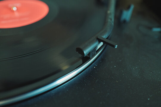 Vinyl record spinning on a turntable with tonearm in view