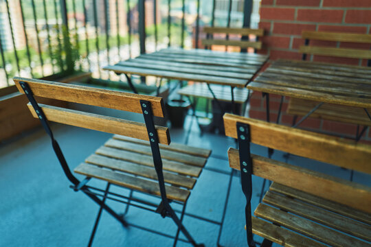 Wooden folding chairs and table on an apartment balcony