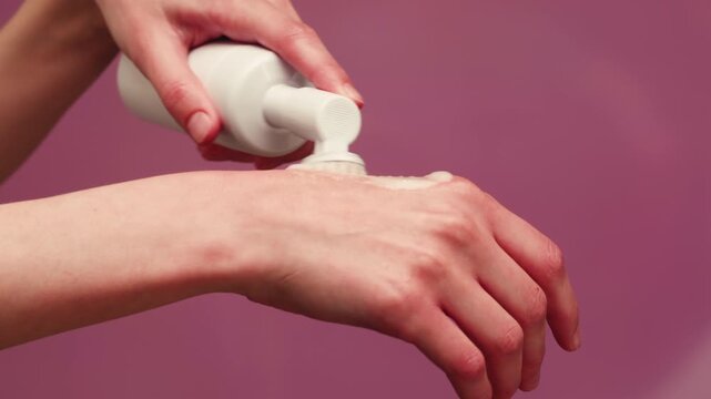 Woman apply cream for hands skin, Close-up of hands with exfoliating cream, demonstrating effective skin care, soft cream foam.