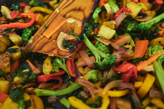 Colourful vegetable stir-fry sizzling in a pan