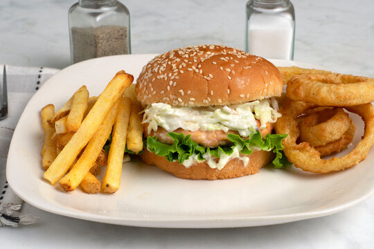 chicken fillet  top with cole  slaw and a side of fries