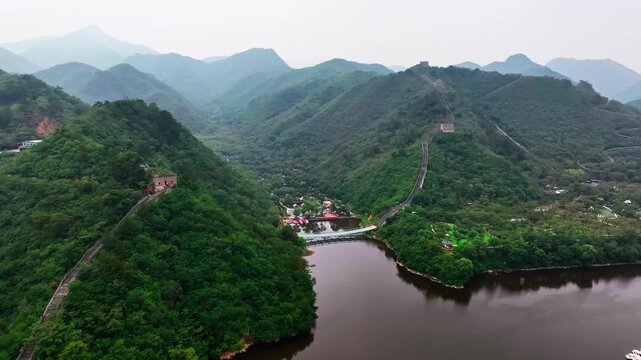 aerial view of a small town on a river surrounded by green mountains