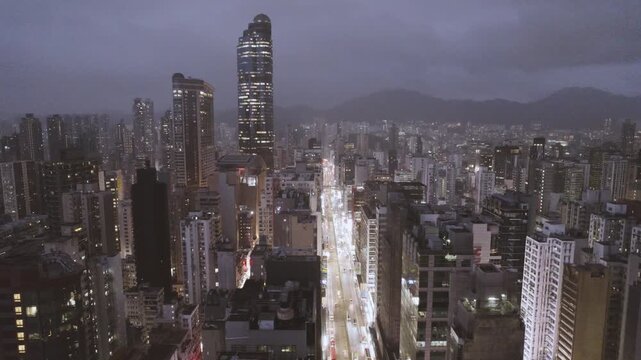 Hong Kong cityscape at dusk with skyscrapers and mountains