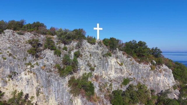 Aerial View of White Cross on Coastal Hill Above Arillas Bay, Epirus, Greece