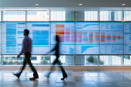 Business analyst walking past data wall, business motion concept
