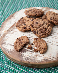 Fototapeta premium Chocolate chip cookies over wooden board